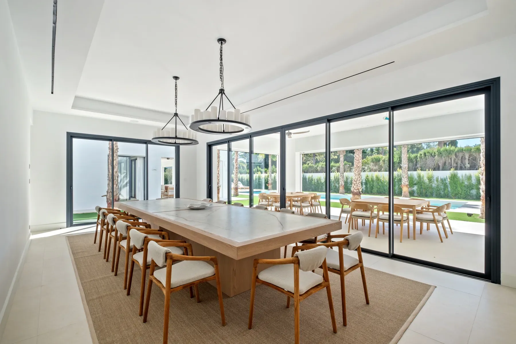 Villa Byblos dining room with a long table for large groups and views over the garden
